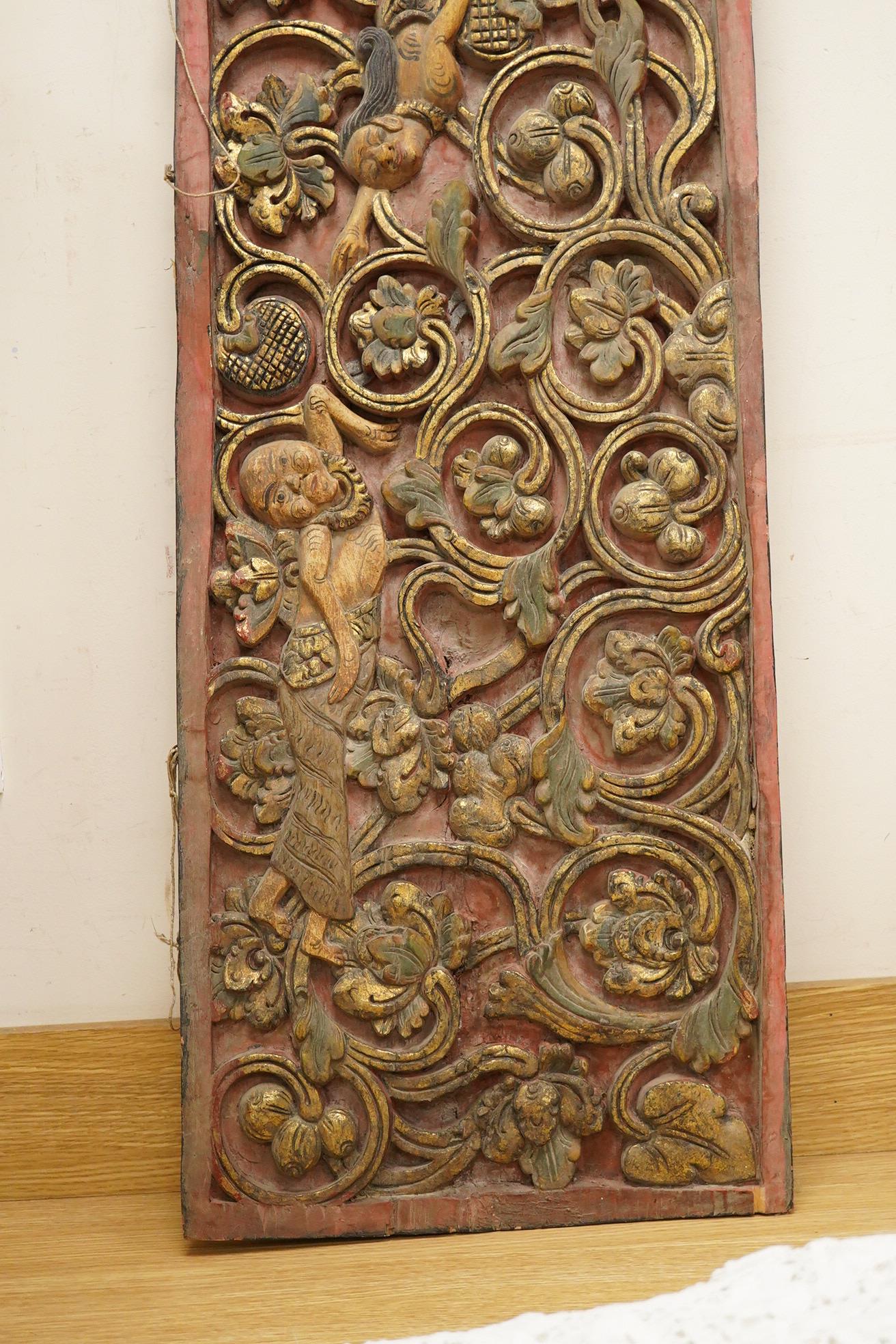 A Balinese partially gilt carved wood panel, 40 x 111cm